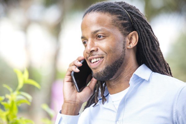 African American businessman talking on cell phone outdoors
