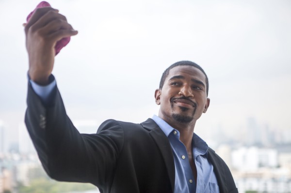 African American businessman taking selfie with cell phone