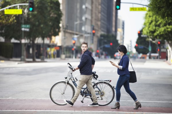 Caucasian business people crossing city street