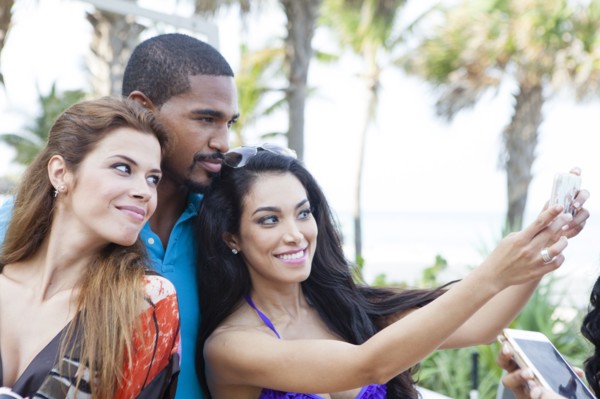 Friends taking selfie with cell phone outdoors