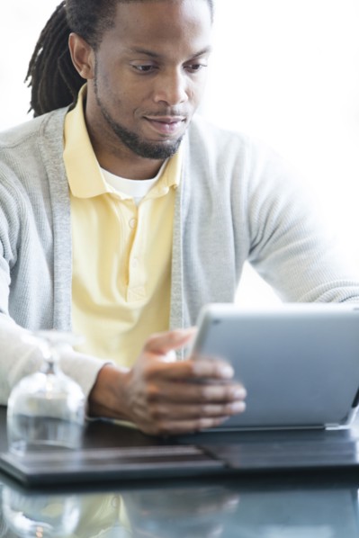 African American businessman using digital tablet in restaurant