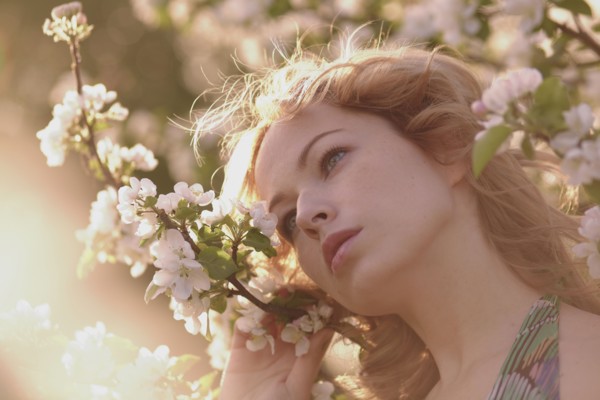 Caucasian woman standing in flowering tree