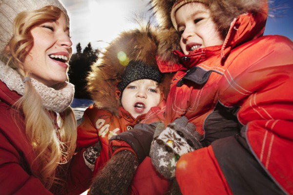 Mother and sons laughing outdoors