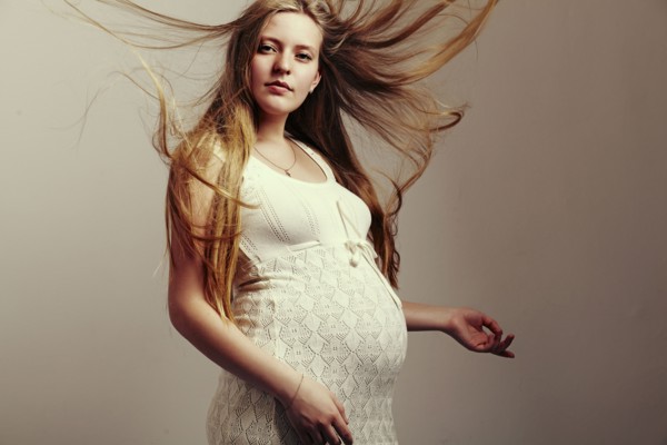 Pregnant woman with windblown hair