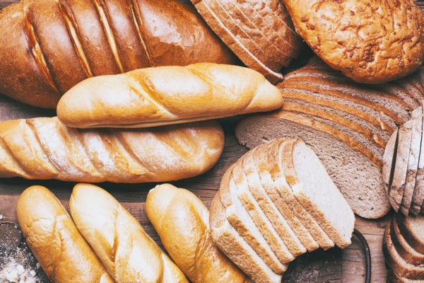 Loaves and sliced bread on table