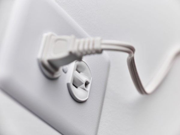 Close up of white plug in outlet
