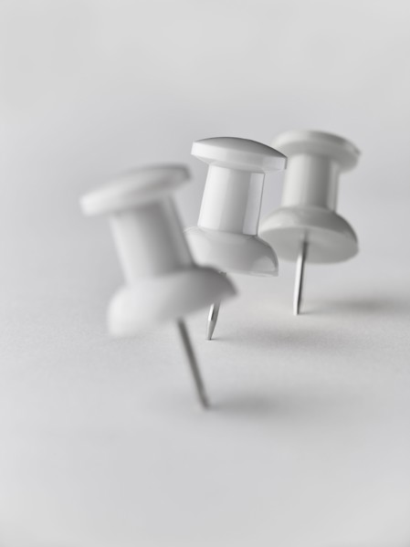 Close up of three white pushpins