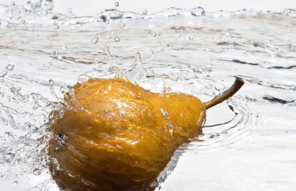 Close up of pear splashing in water