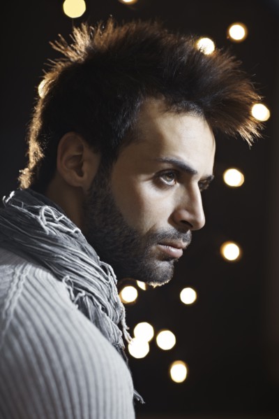 Serious Caucasian man with beard at night