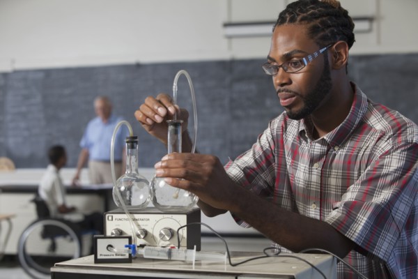 Student performing experiment in science classroom