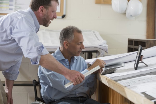 Caucasian architects talking in office