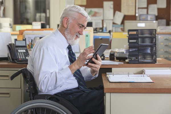 Caucasian businessman using digital tablet in office