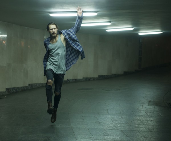 Carefree Caucasian man skipping in tunnel