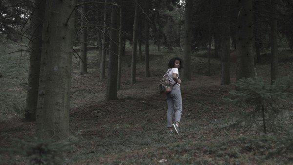 Fearful woman running in woods
