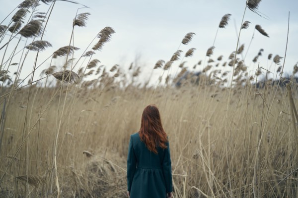 Rear view of Caucasian woman standing in field