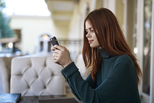Caucasian woman texting on cell phone at restaurant