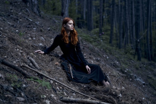 Caucasian woman sitting on hill