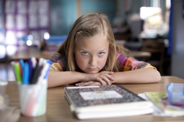 Bored Caucasian girl sitting in classroom
