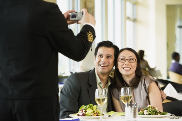 Couple having photograph taken at restaurant