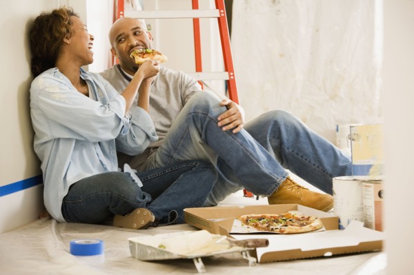 African couple taking lunch break from painting