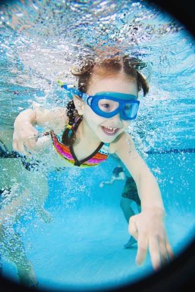 Asian girl swimming under water