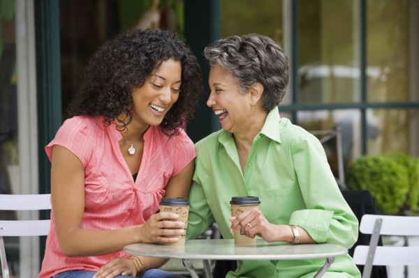 African American mother and adult daughter laughing