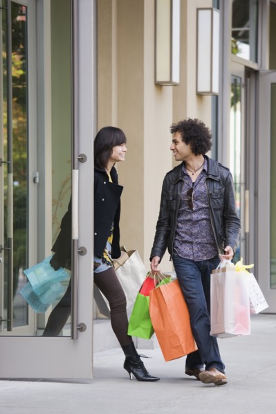 Couple leaving store with shopping bags