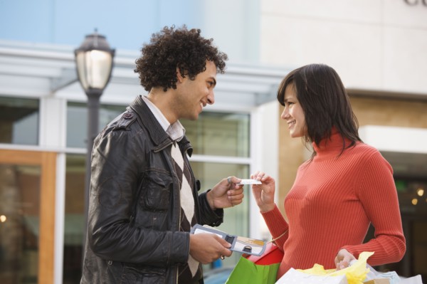 Middle Eastern man giving girlfriend credit card