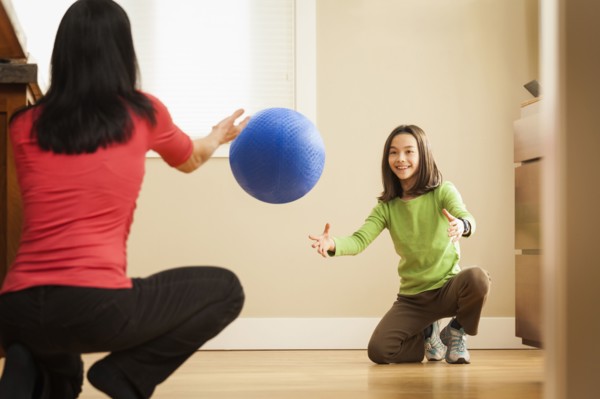 Mother and daughter playing with ball