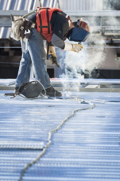 Caucasian construction worker welding floor