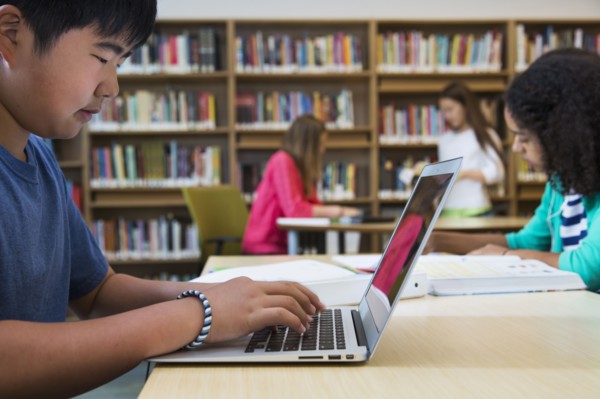 Student using laptop in library