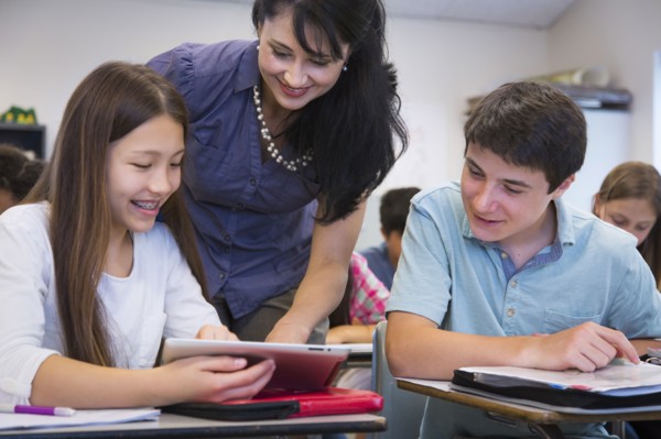 Teacher helping students in class