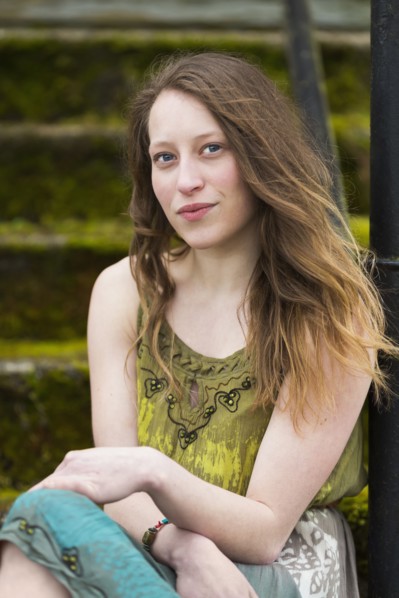 Caucasian teenage girl sitting on steps outdoors
