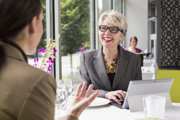 Caucasian businesswomen working in restaurant