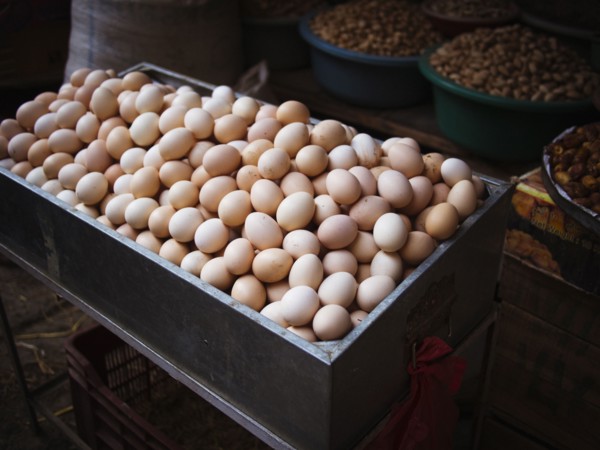Bin of fresh eggs for sale in market