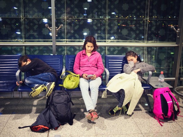 Mother and children relaxing in airport waiting area