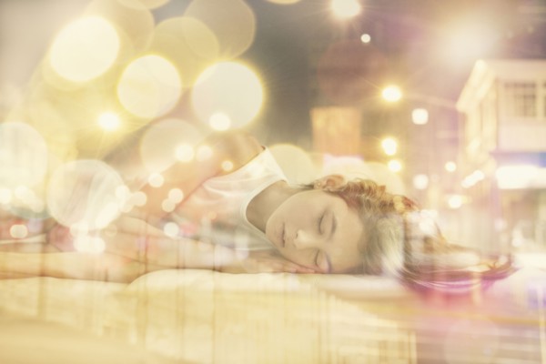 Mixed race girl dreaming of city at night