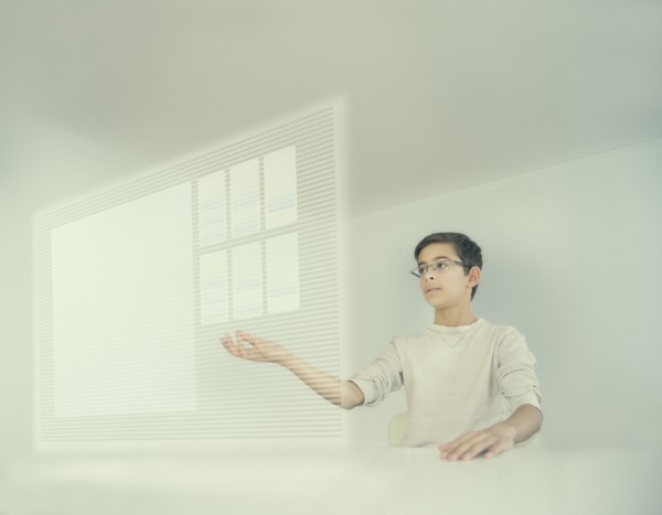 Mixed race boy using holographic screen