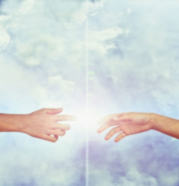 Bright fingers touching in sky