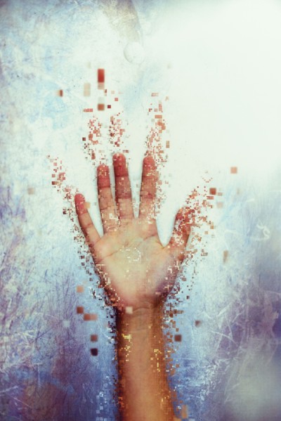 Pixelated hand dissolving
