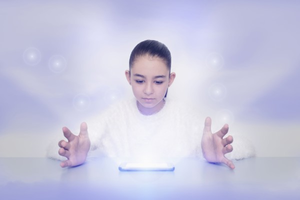 Mixed race girl with glowing digital tablet