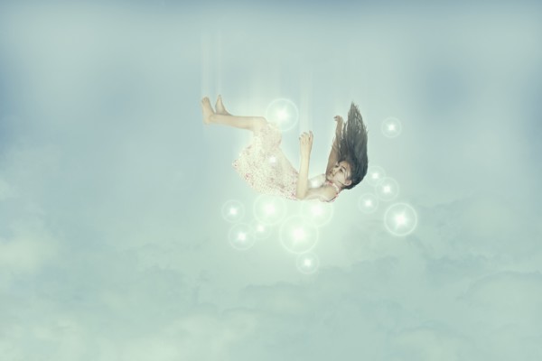 Mixed race girl falling in sky