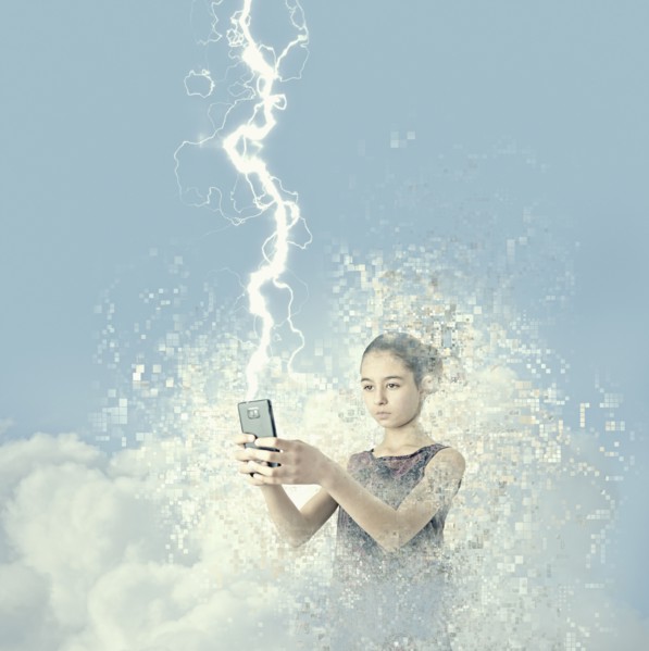 Mixed race girl holding cell phone in lightning