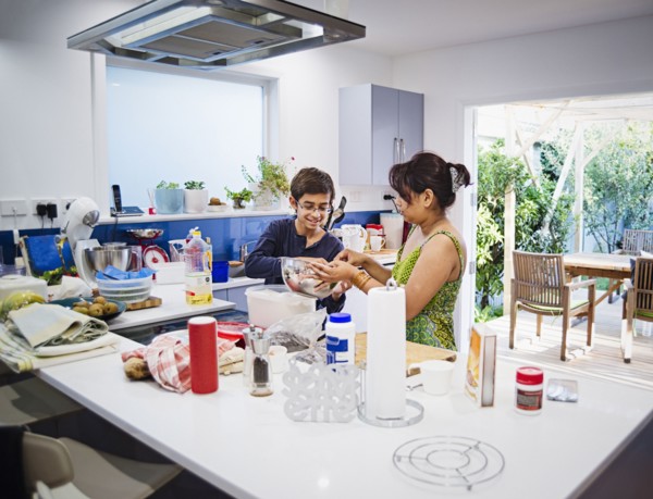 Mother and son cooking in kitchen