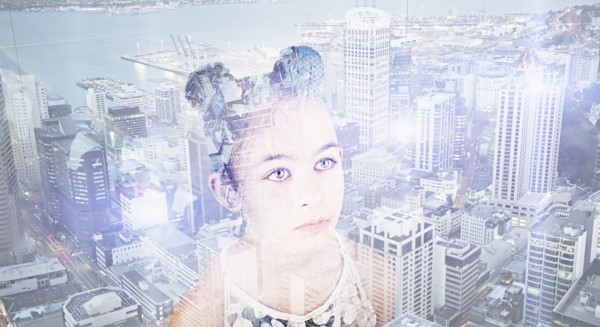 Double exposure of Mixed Race girl over urban waterfront