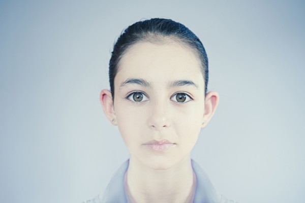Face of wide-eyed Mixed Race girl