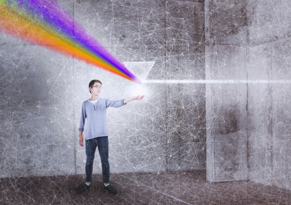 Mixed Race boy holding prism