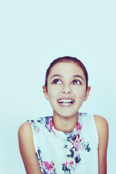 Portrait of smiling Mixed Race girl with big eyes