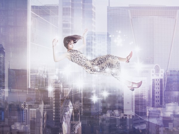 Mixed Race girl floating in city