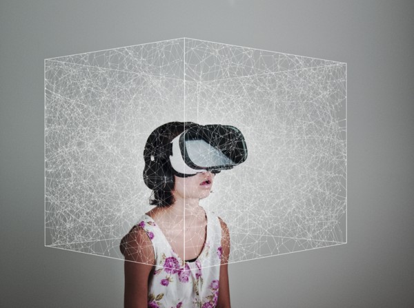 Mixed Race girl wearing virtual reality goggles in floating box